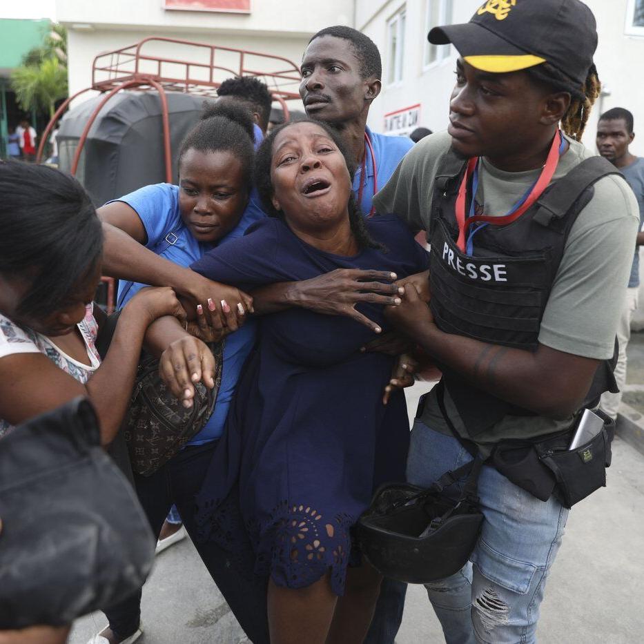 A Haiti gang attack on the reopening of a main hospital kills 2 reporters and a police officer